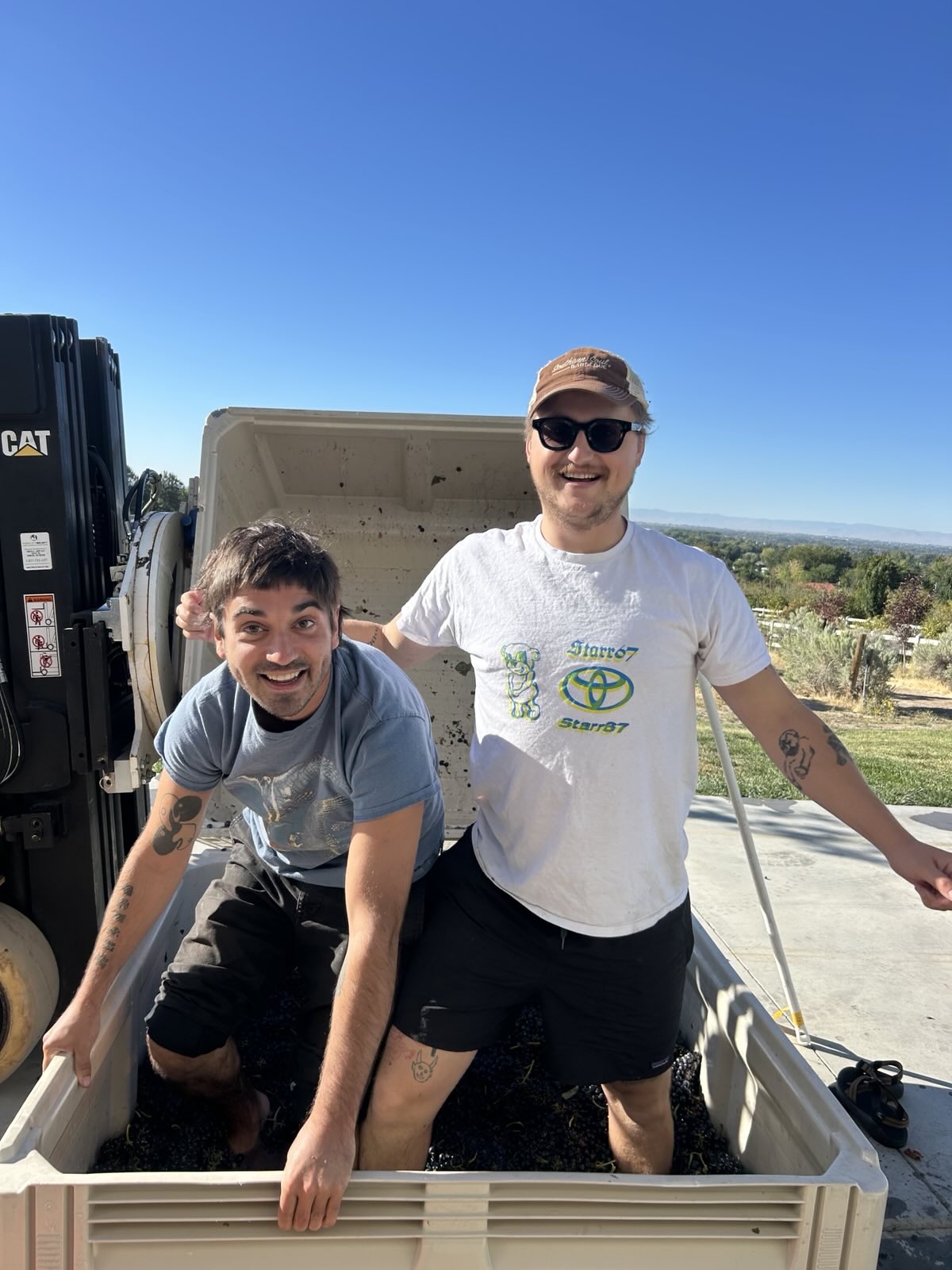 Max and Carter crushing grapes